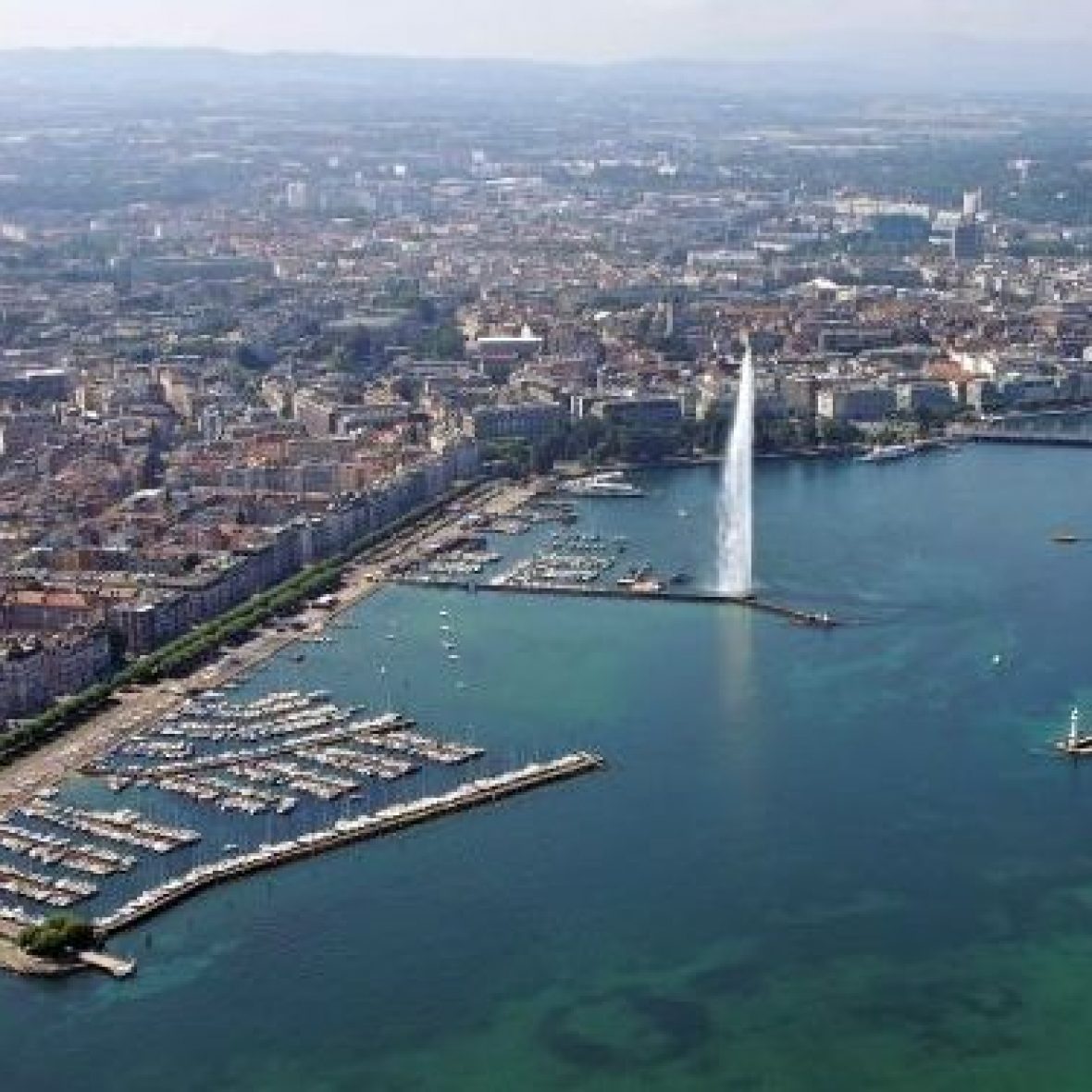 Geneva coastline with blue water and distant cityscape