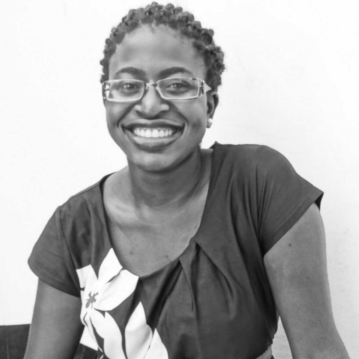 Watson Fellow Wadzanai Motsi smiles at the camera, wearing a t-shirt, in black and white