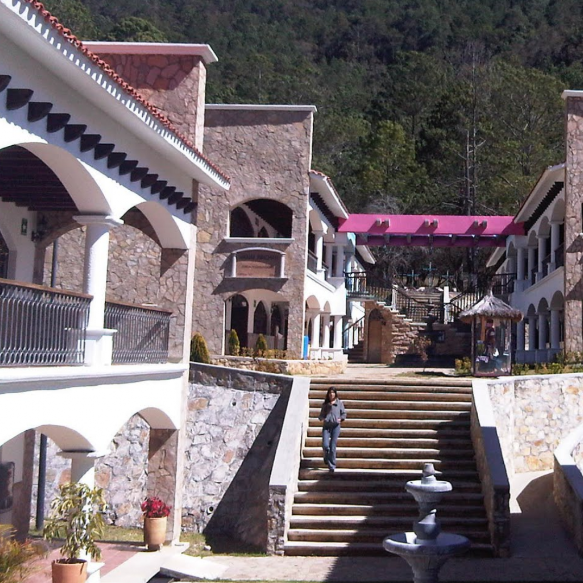 Intercultural University of Chiapas outdoor area with white steps, pink roof, and various balconies
